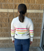 white sweater with bright colored stripes