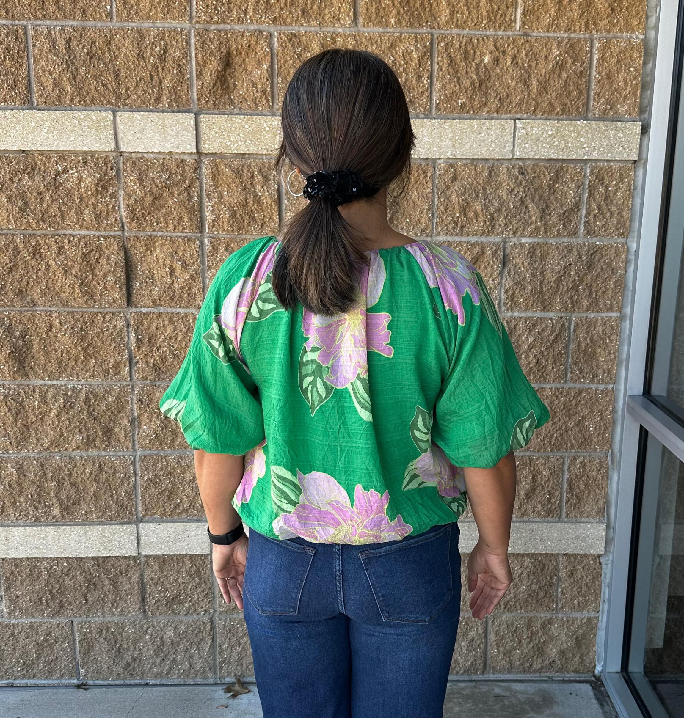 green blouse with floral print and bubble hem